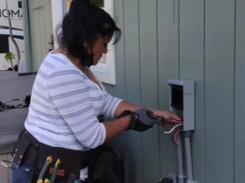 Licensed electrician wiring an exterior subpanel in Bartlett