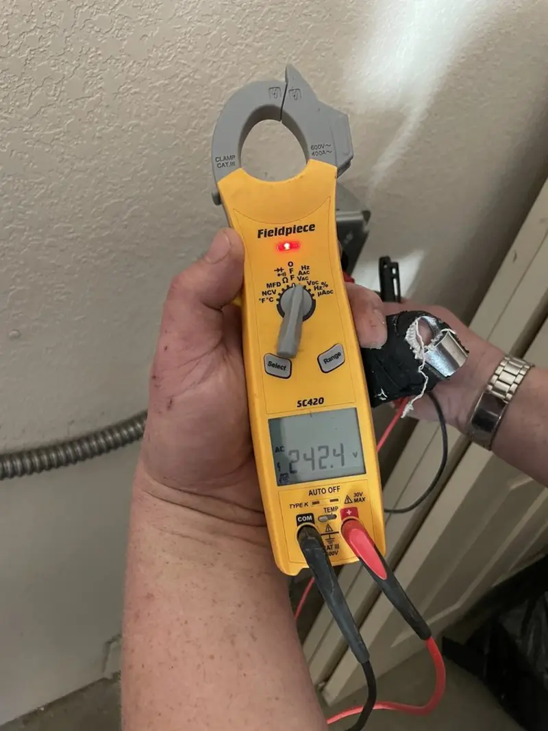 Voltage testing with clamp meter during Outlet Installation in Bartlett